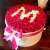 A large cake with roses in it on top of a table.