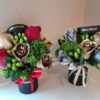 Two bouquets of flowers in a black vase