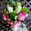 A bouquet of flowers in a vase on top of a table.