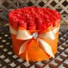 A large orange box with red roses in it.