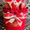 A red bucket with many different types of candy.